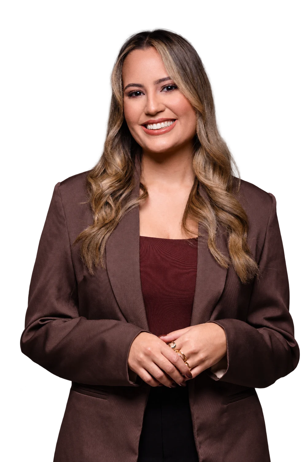Emylly Belmiro, advogada, sorrindo, de blazer marrom